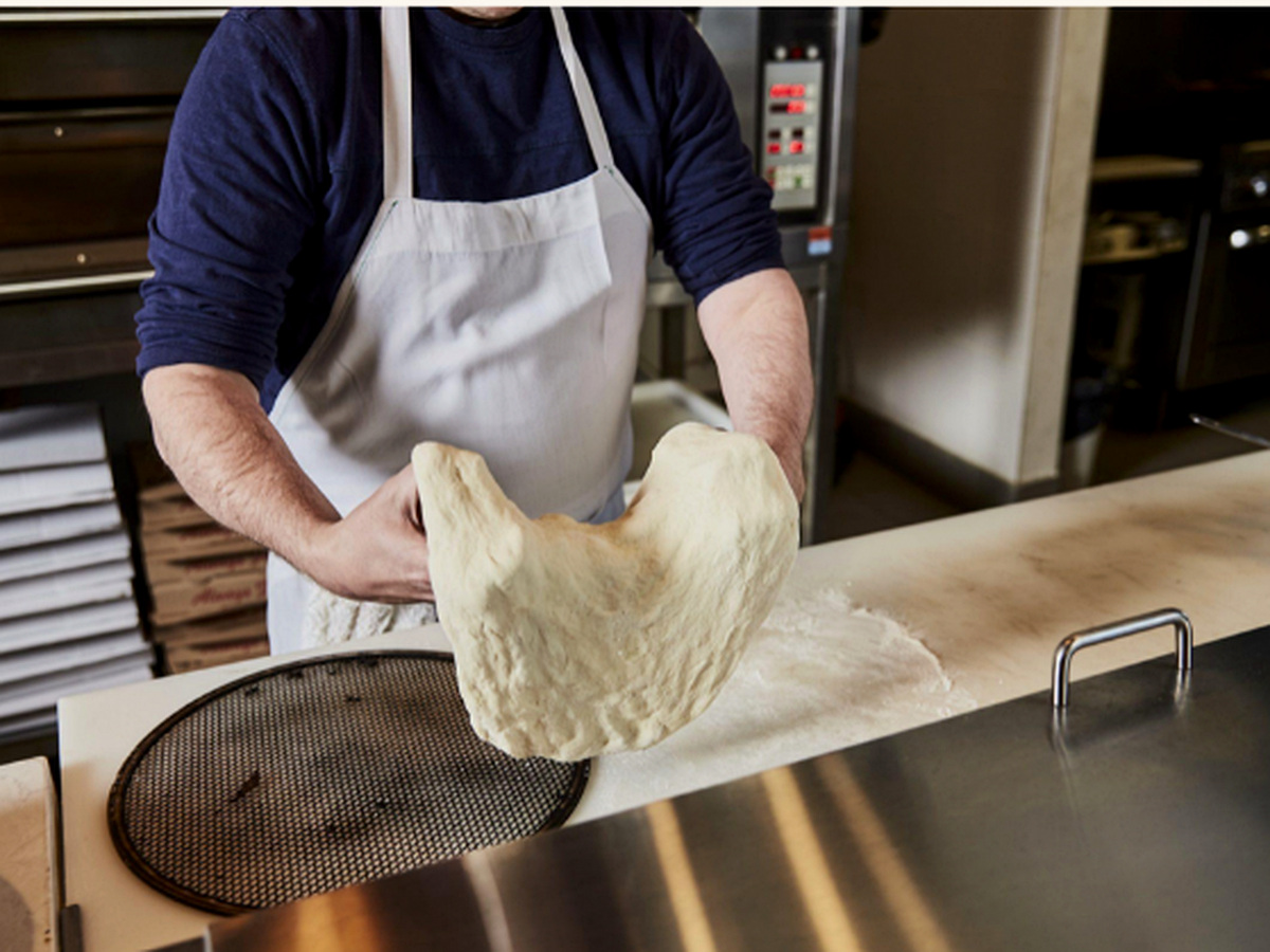 Pizza dough being stretched at Capri