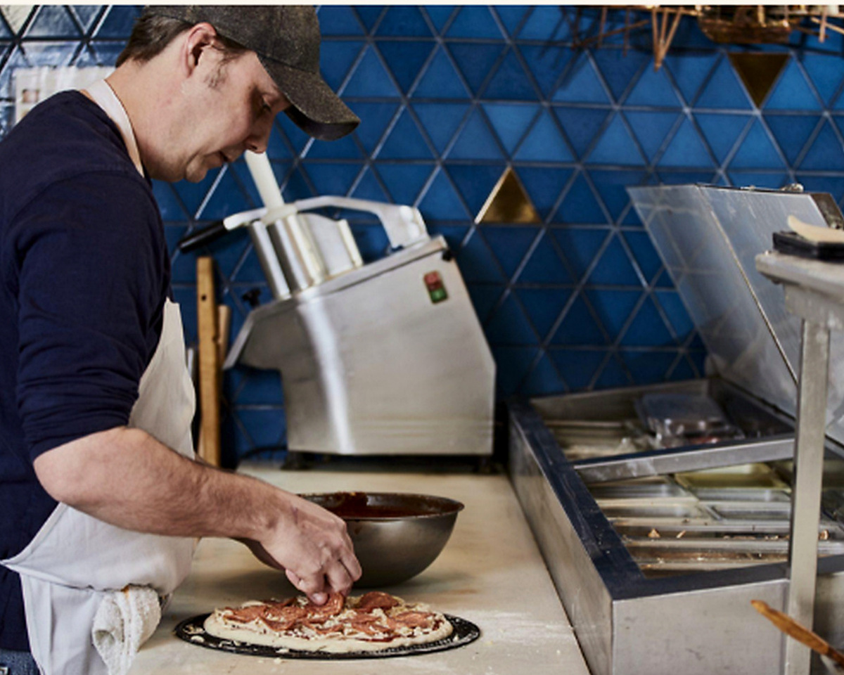 Capri kitchen team preparing pizza